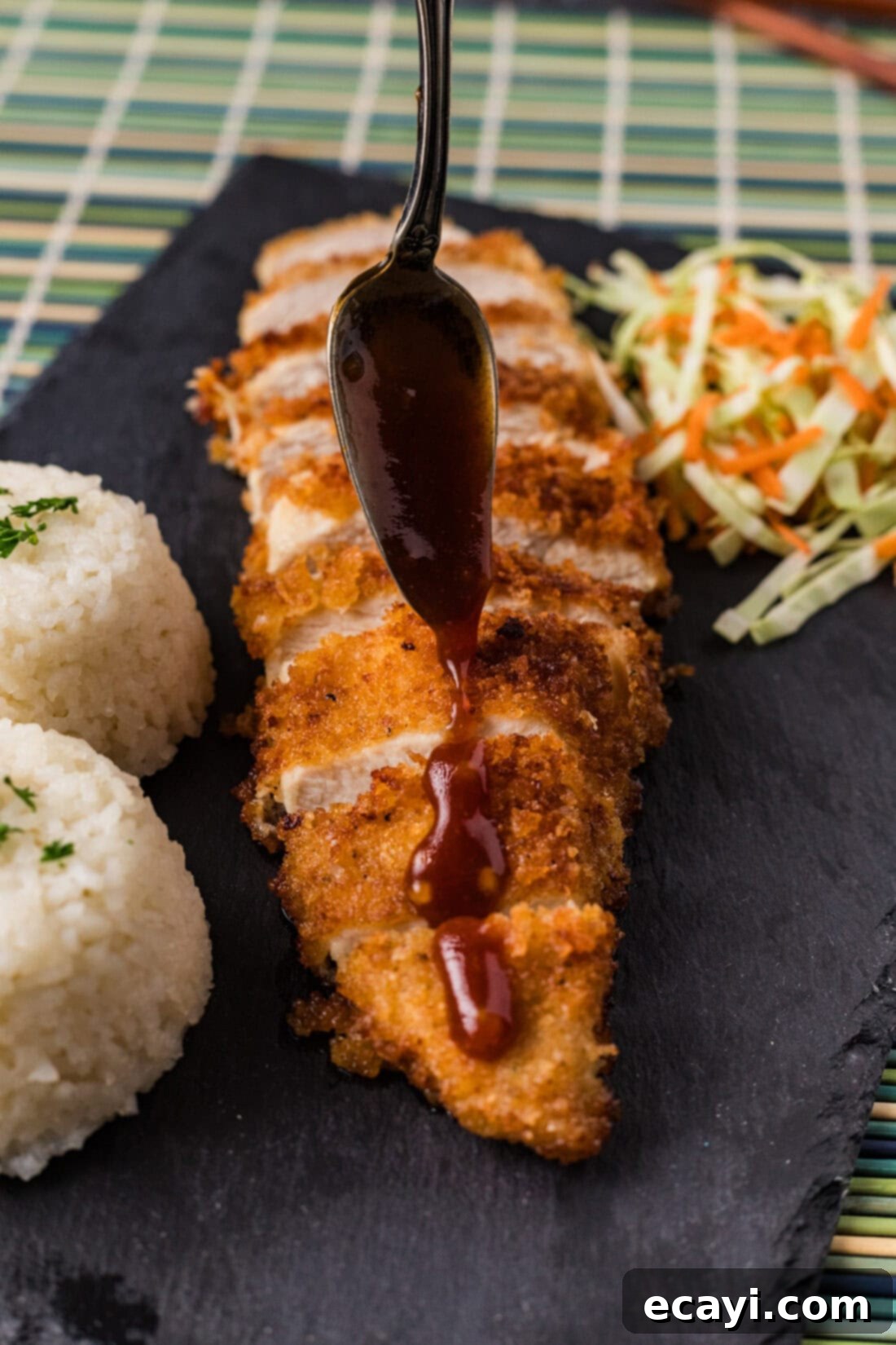 Golden Panko Chicken Cutlet 12 Glaze being drizzled over Chicken Katsu