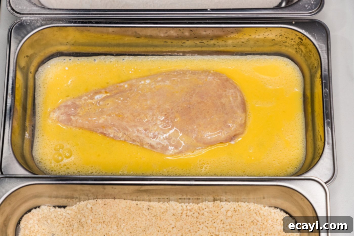 Golden Panko Chicken Cutlet 9 dredging chicken breast in egg