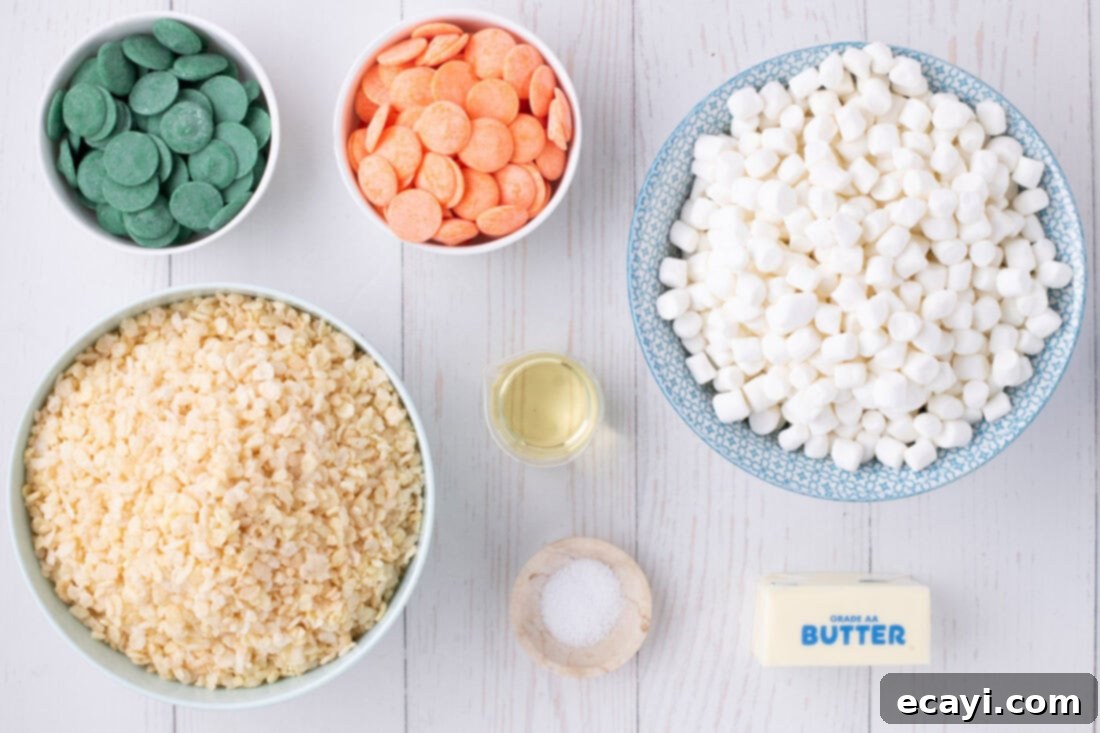 Carrot Cake Krispie Squares 4 All the necessary ingredients laid out for making Carrot Rice Krispie Treats, including marshmallows, cereal, butter, and candy melts.