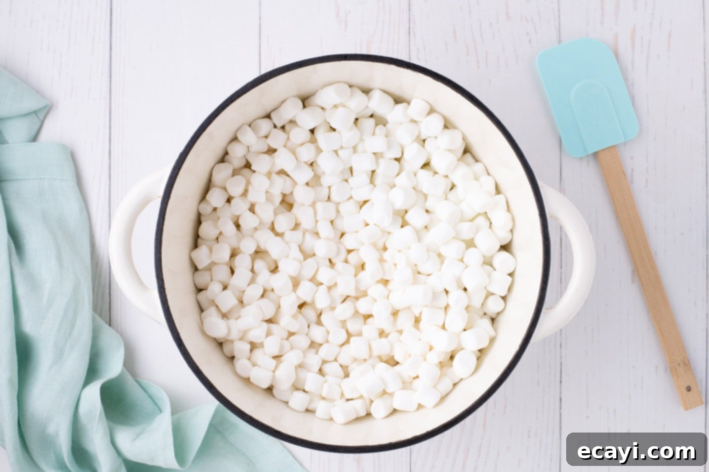 Carrot Cake Krispie Squares 5 Mini marshmallows melting in a large Dutch oven with butter and salt