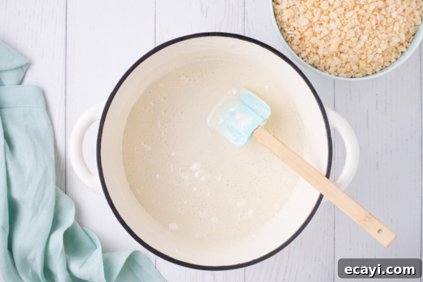 Carrot Cake Krispie Squares 6 Smooth, melted marshmallow mixture in a pot, stirred with a rubber spatula