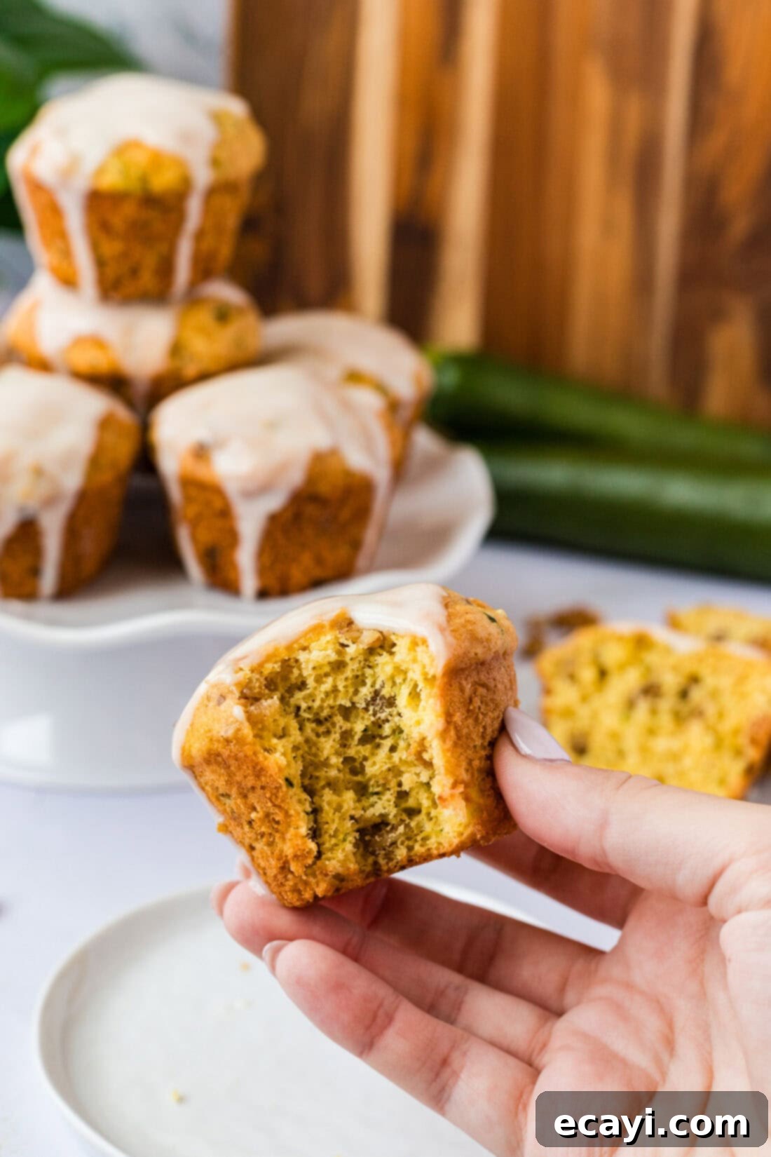 Quick Zucchini Muffins 11 Hand holding a Shortcut Zucchini Muffin with a bite taken out