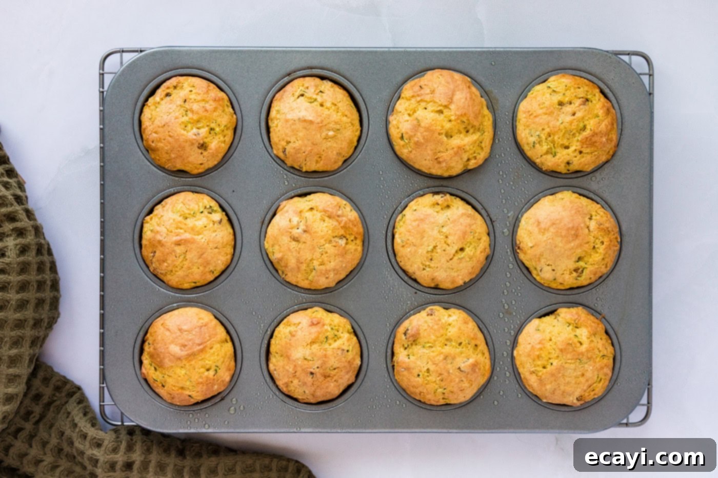 Quick Zucchini Muffins 8 Baked muffins in a pan