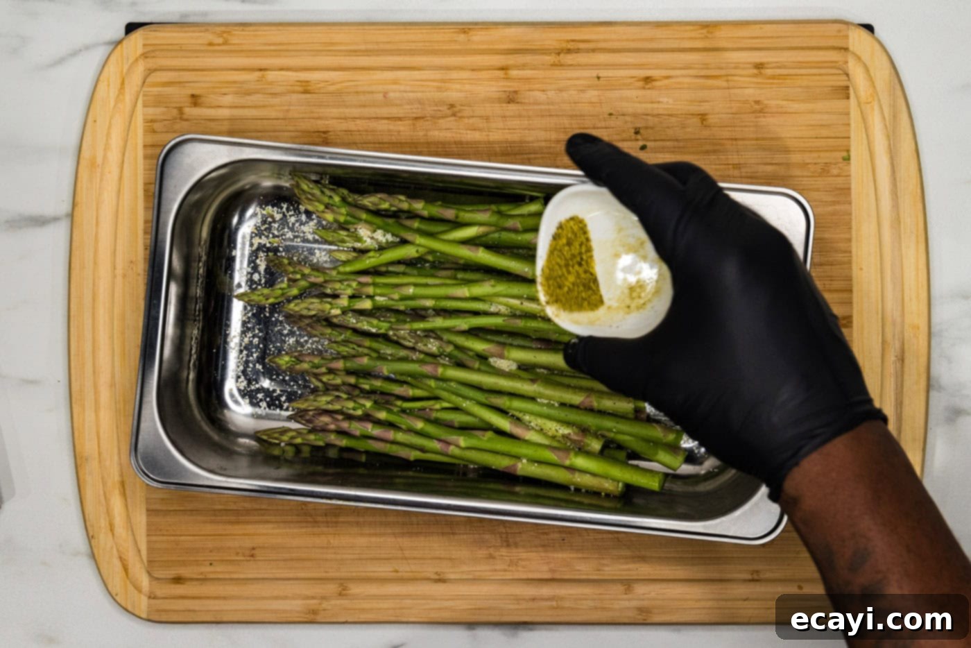Bright Lemon Asparagus 5 seasoning asparagus in a pan with lemon pepper
