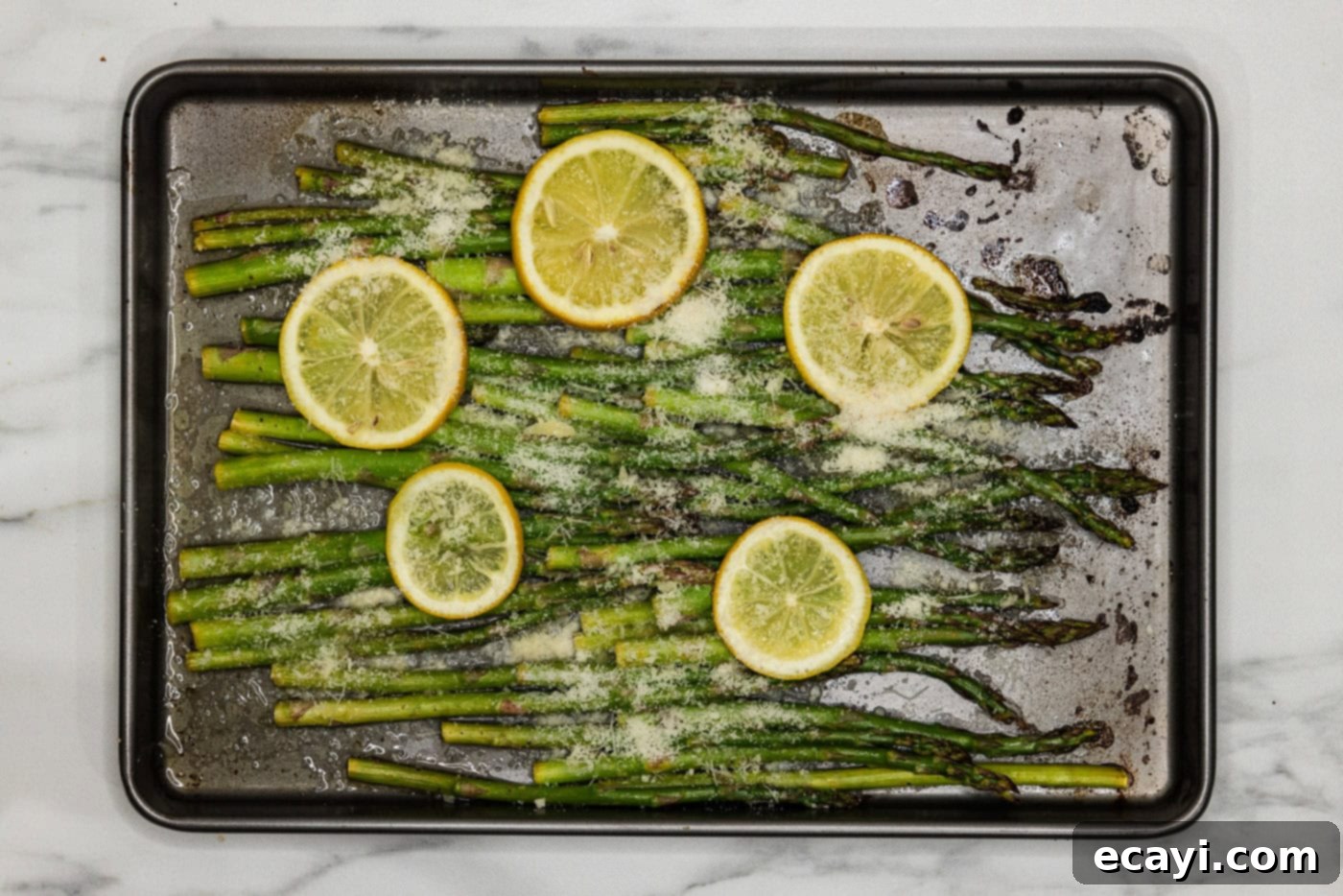 Bright Lemon Asparagus 8 lemon asparagus on a baking pan wih parmesan cheese