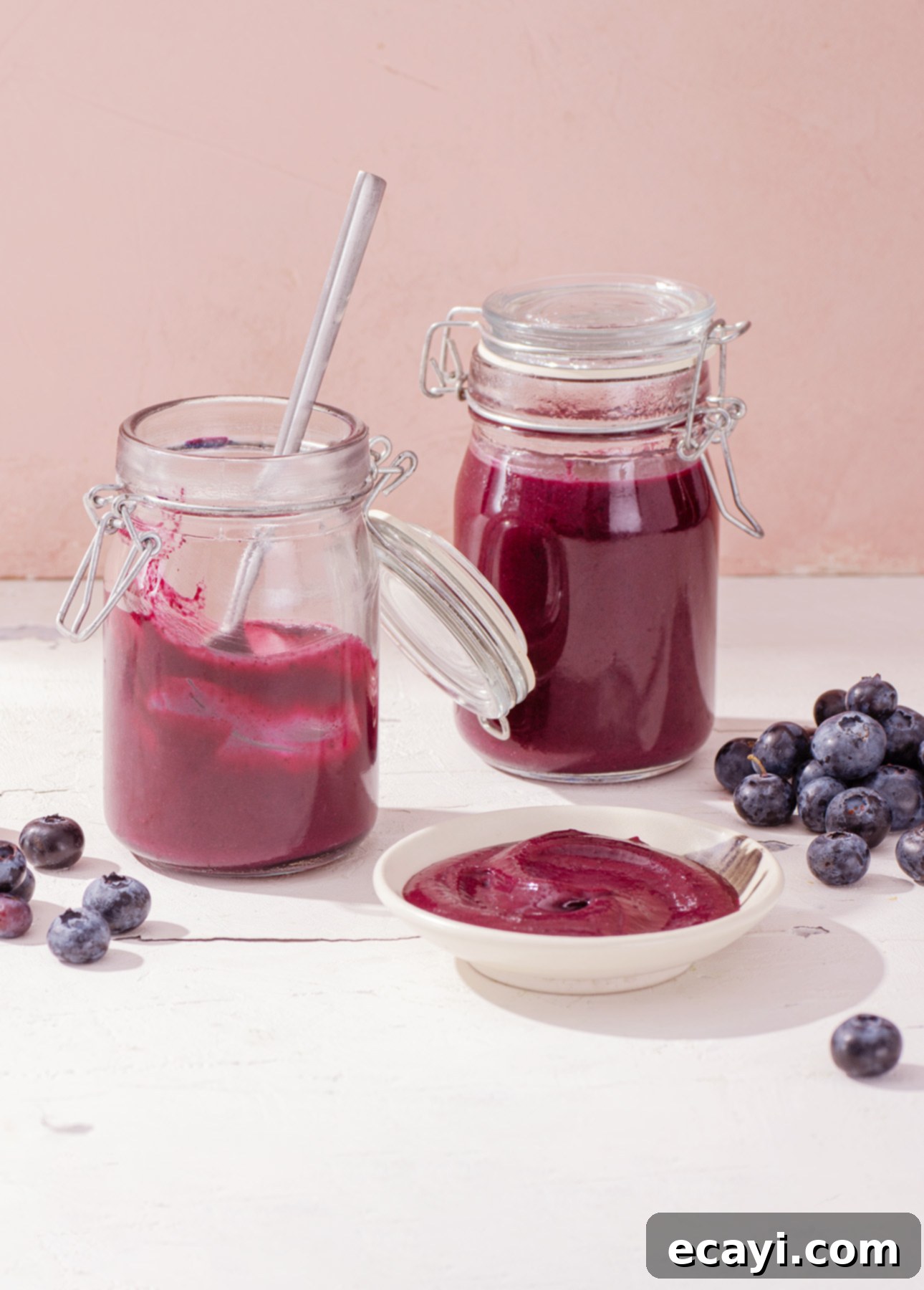 Velvety Blueberry Spread 5 Blueberry curd in a glass jar with a spoon, ready to be served as a striking brunch condiment.