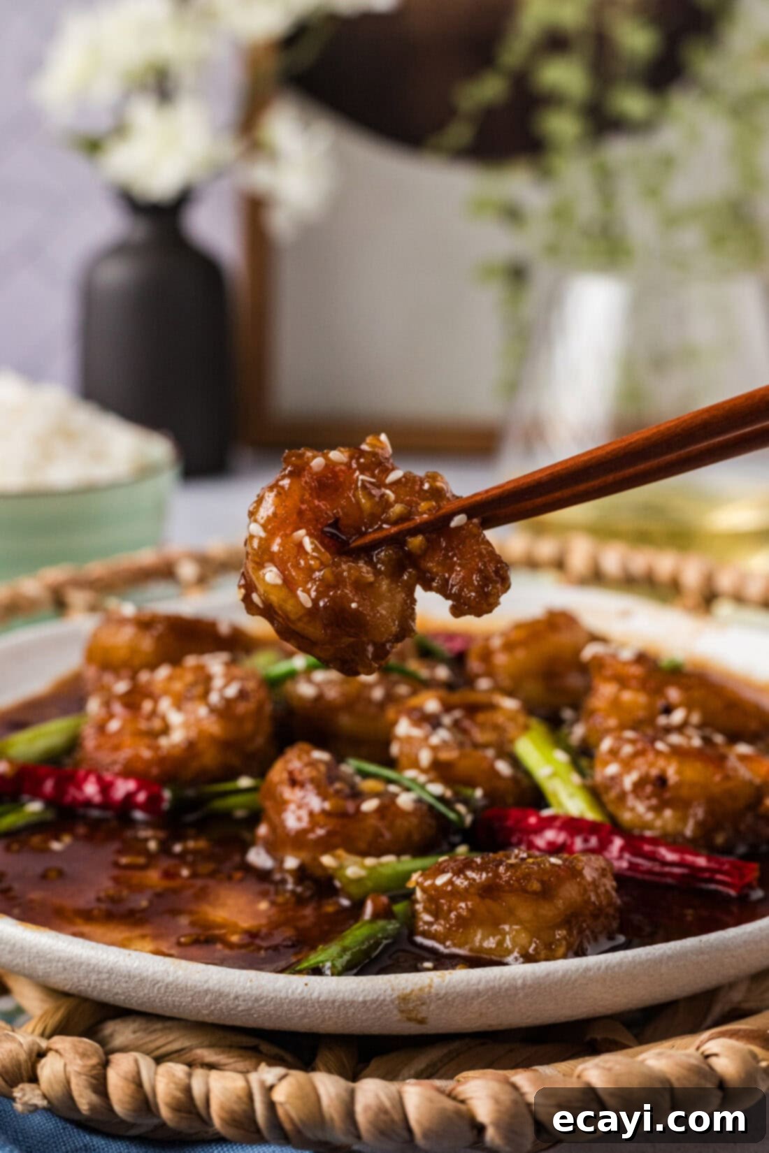 Glazed Mongolian Shrimp 3 Chopsticks holding a Mongolian Shrimp