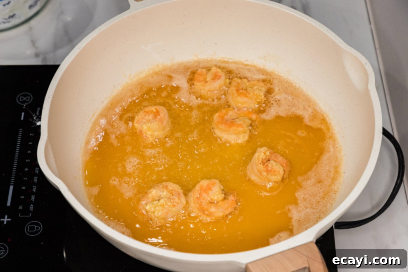 Glazed Mongolian Shrimp 8 frying breaded shrimp in a skillet of oil