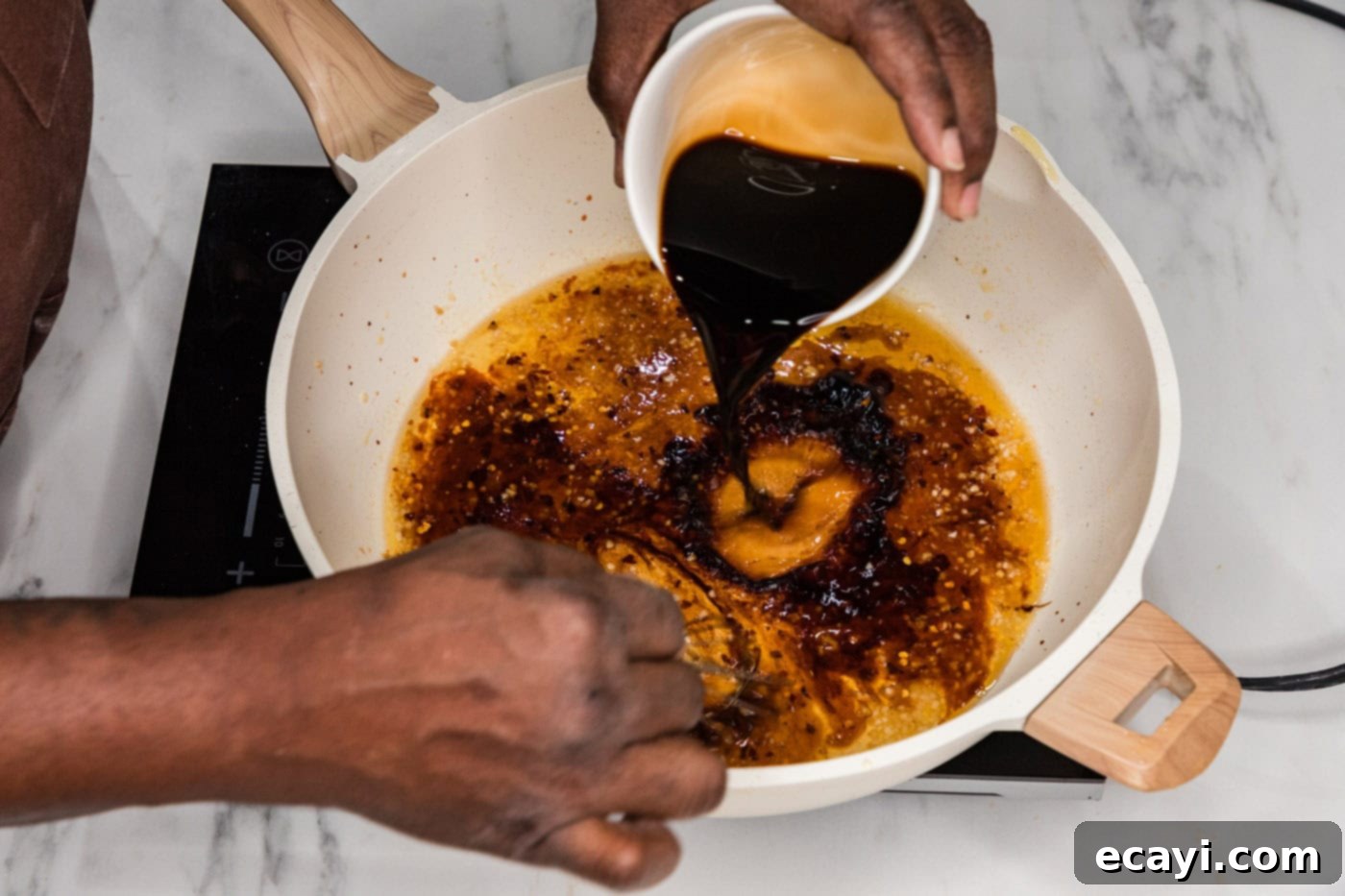 Glazed Mongolian Shrimp 9 whisking oyster sauce into sauce in a skillet