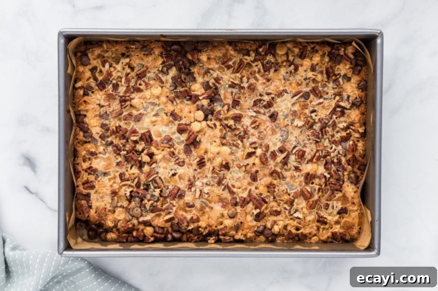 Pure Magic Dessert Bars 11 An overhead view of the freshly baked, golden-brown magic bars, slightly puffed and caramelized.