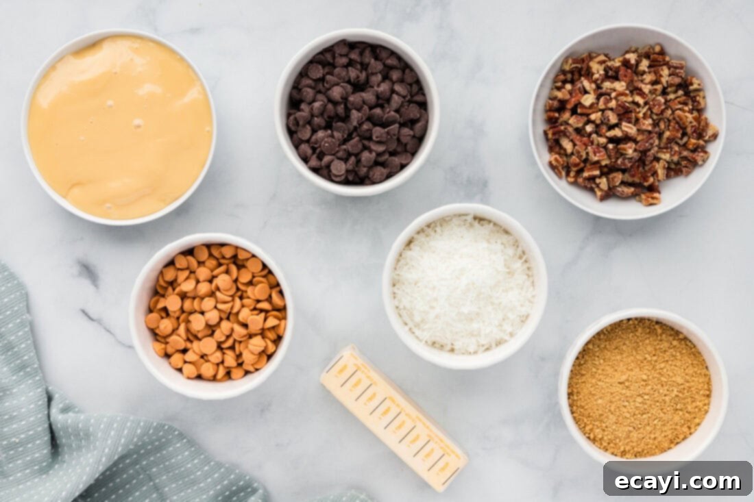 Pure Magic Dessert Bars 4 A flat lay of all the essential ingredients needed to make delicious Magic Bars, including butter, graham crackers, chocolate chips, coconut, condensed milk, and pecans.