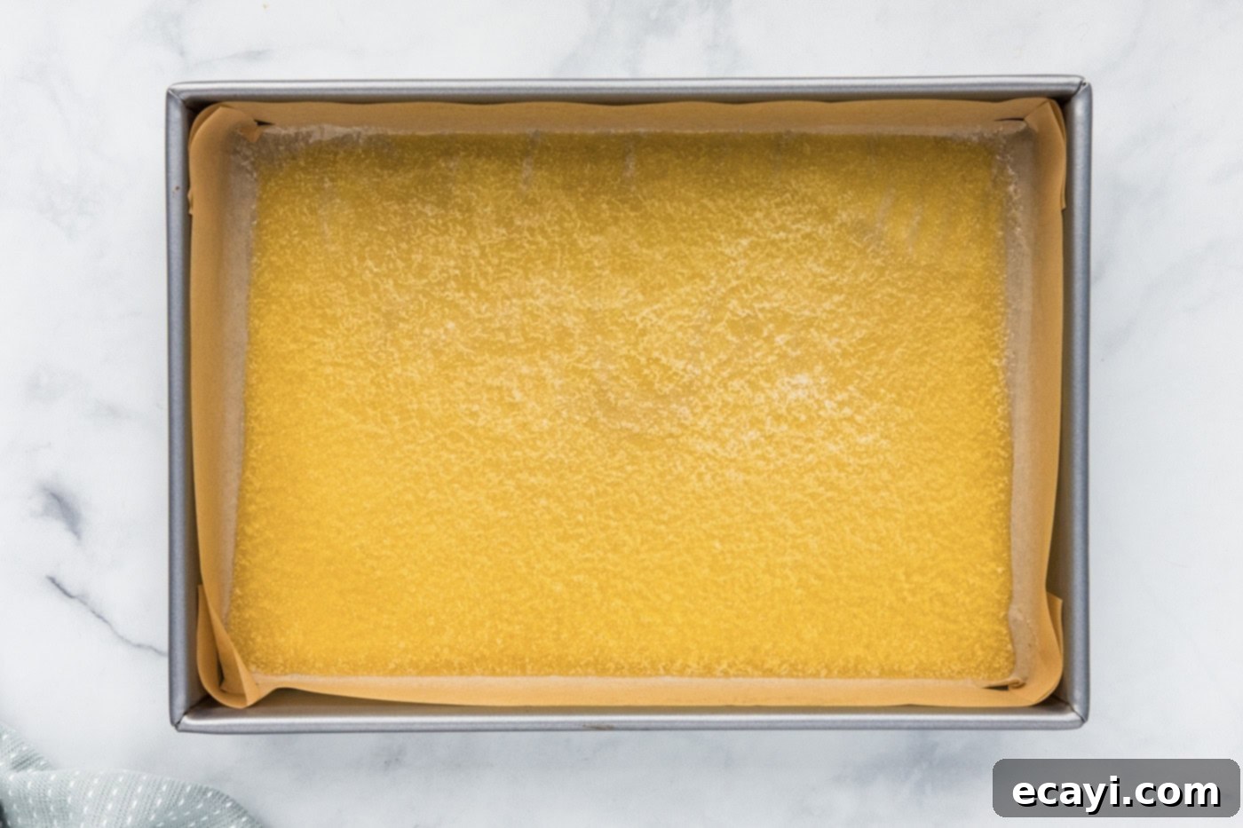 Pure Magic Dessert Bars 5 Melted butter pooled at the bottom of a 9x13 inch baking pan.
