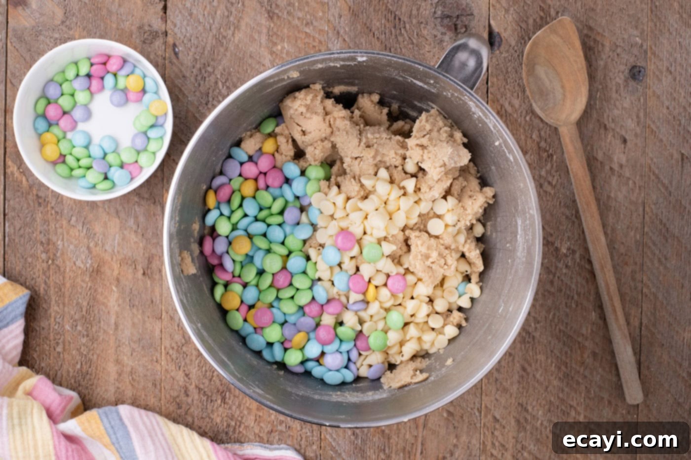 Colorful Easter M&M Cookies 11 white chocolate chips and M&Ms added to cookie dough in a bowl