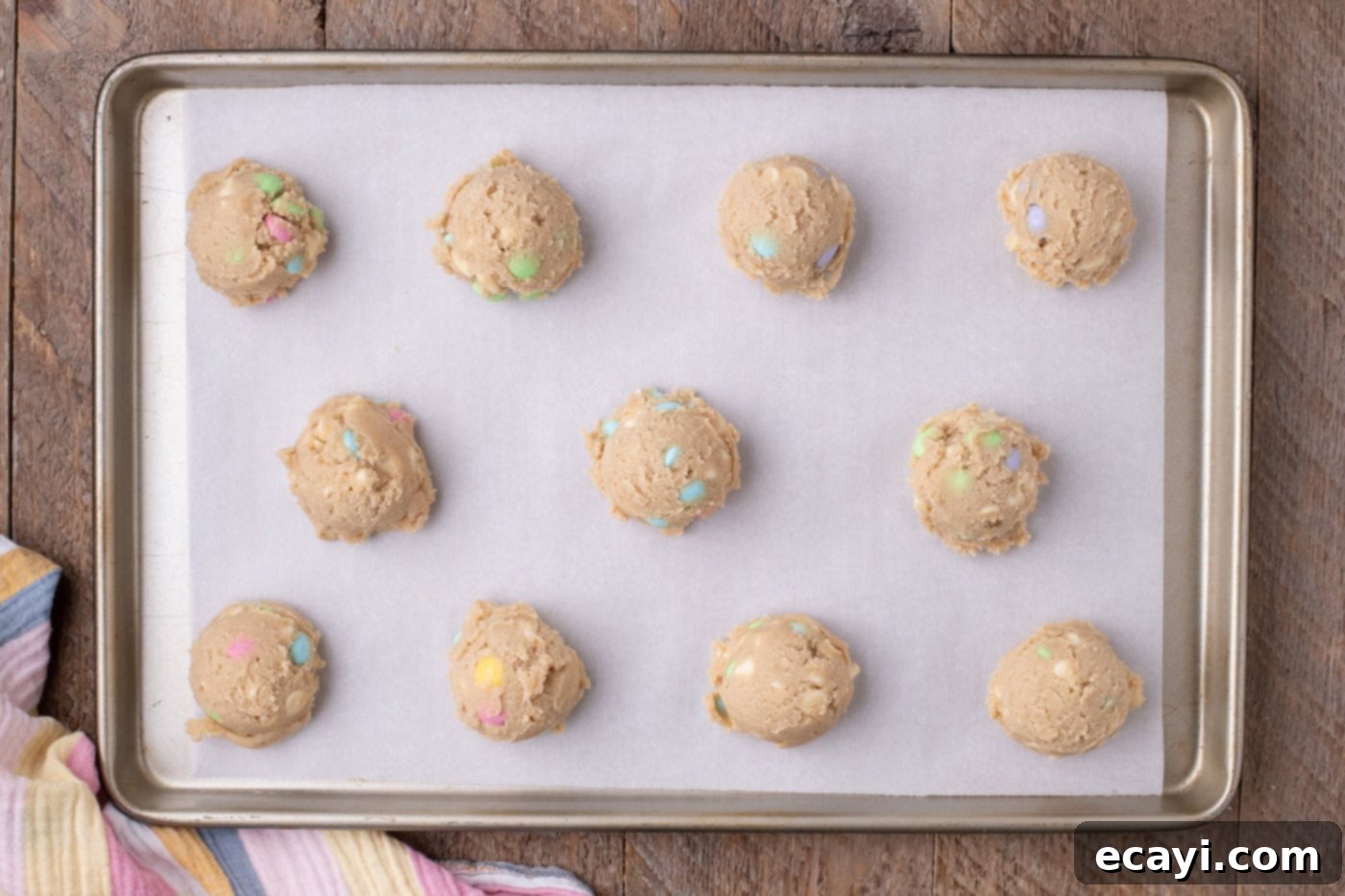 Colorful Easter M&M Cookies 12 mounds of cookie dough on a baking sheet
