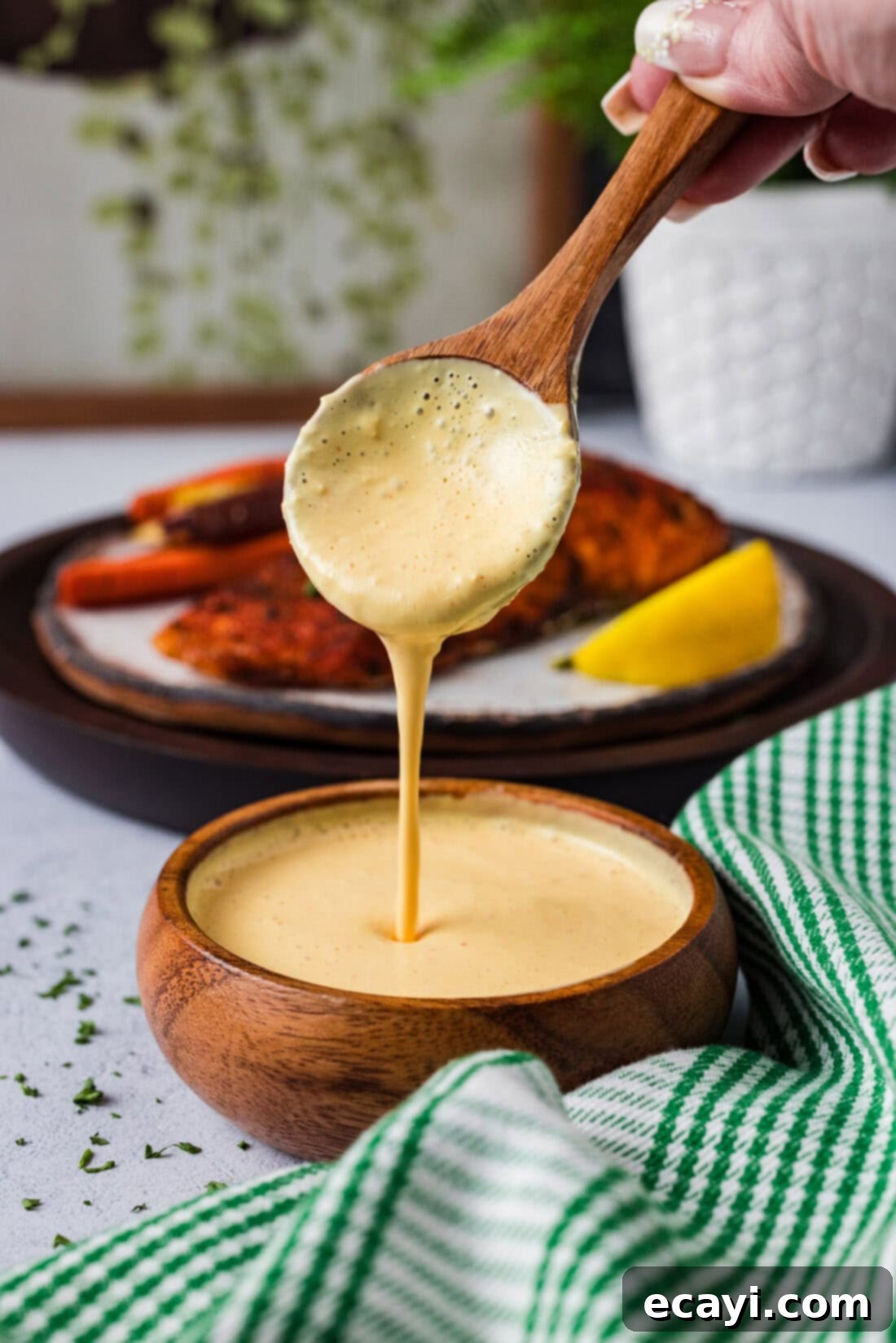 Classic Remoulade 2 Spoon pouring freshly made Remoulade Sauce into a decorative bowl, highlighting its creamy texture and vibrant color.