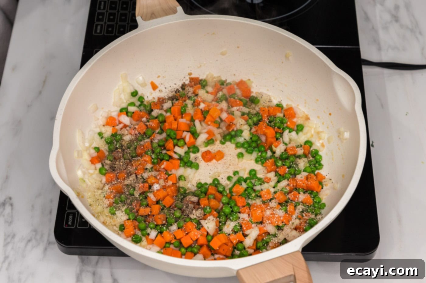 Golden Fried Rice Delights 6 Carrots, peas, and onion in a skillet with oil and garlic, stir-frying