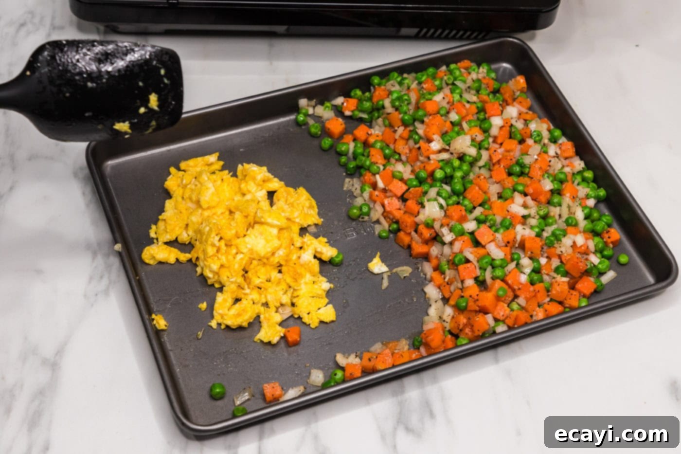 Golden Fried Rice Delights 8 Scrambled eggs and stir-fried vegetables on a pan, ready to be combined