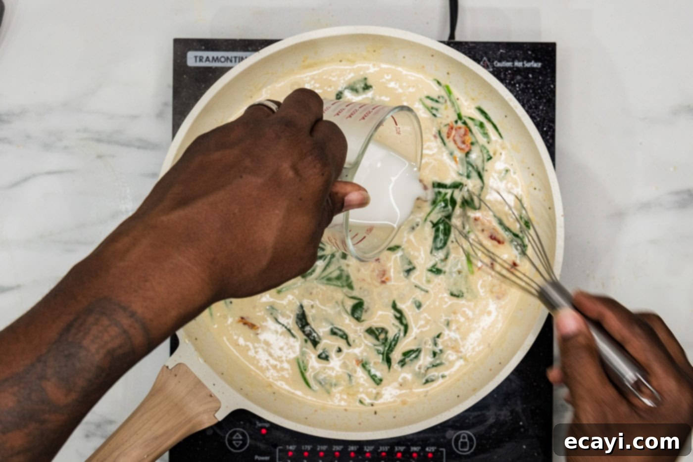 Creamy Tuscan Salmon 10 pouring cornstarch slurry into skillet with cream sauce