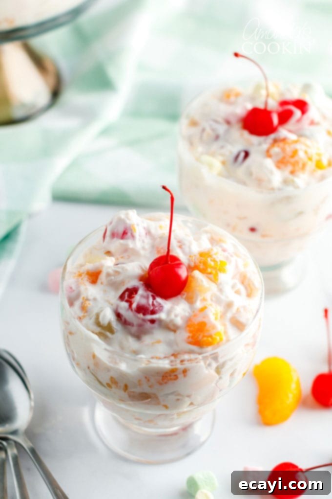 Heavenly Ambrosia Fruit Delight 2 Beautiful dessert dish filled with a generous serving of colorful Ambrosia Salad, showcasing the fruit and marshmallows.