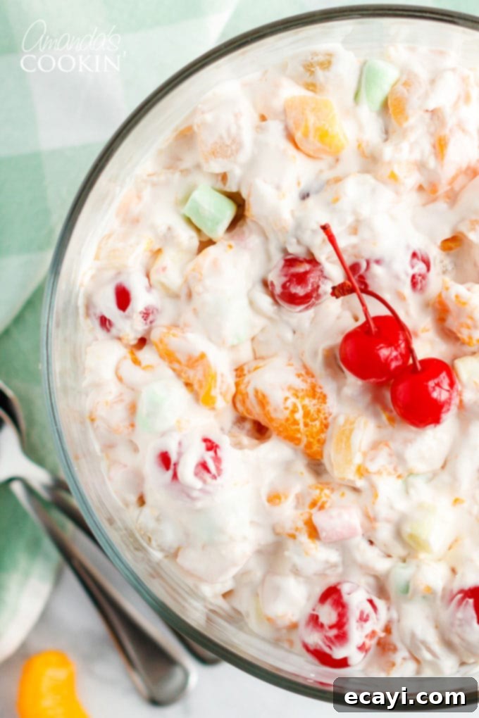 Heavenly Ambrosia Fruit Delight 3 Close-up shot of a large glass bowl filled with Ambrosia Salad, highlighting the creamy texture and medley of fruits.