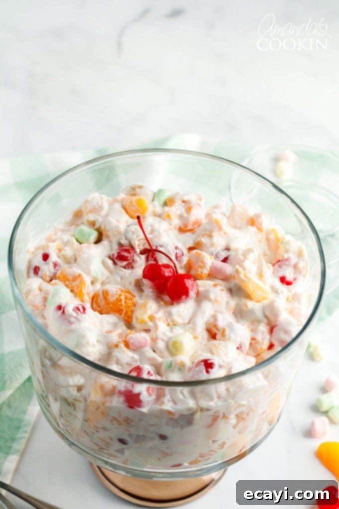 Heavenly Ambrosia Fruit Delight 4 A large, clear glass bowl brimming with freshly made Ambrosia Salad, ready to be chilled and served.