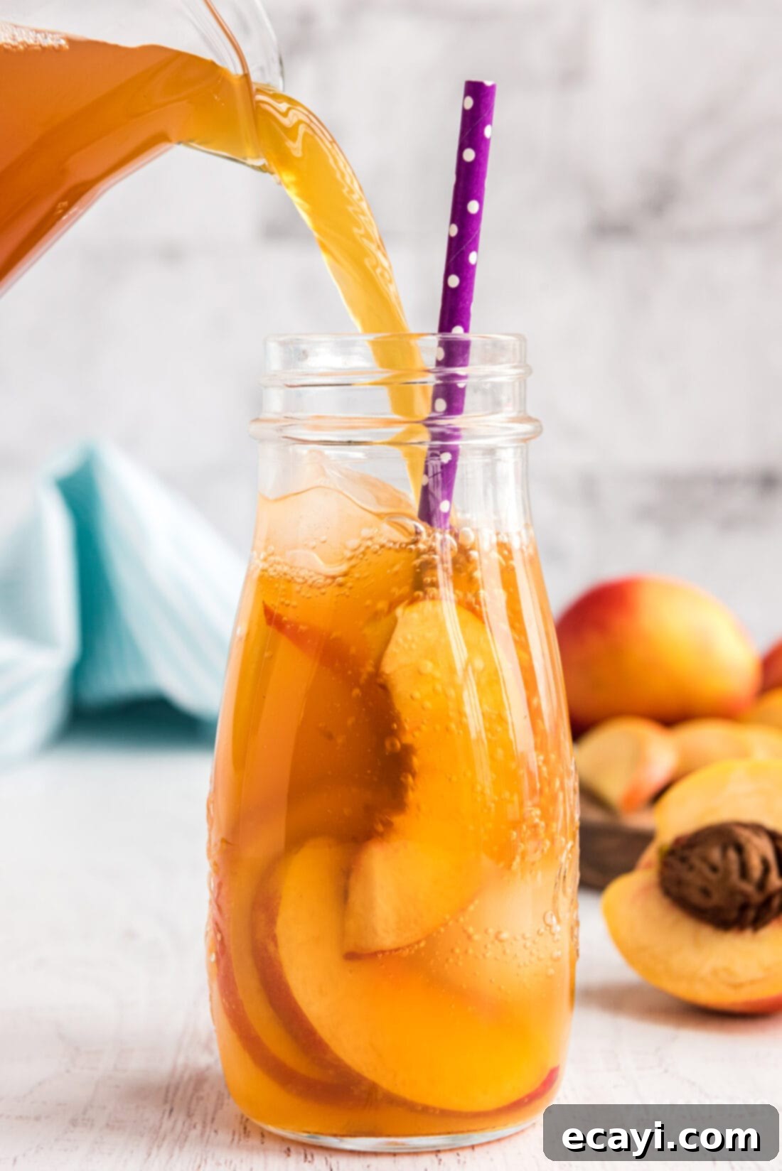 Sun-Kissed Peach Brew 2 Freshly poured peach iced tea into a glass