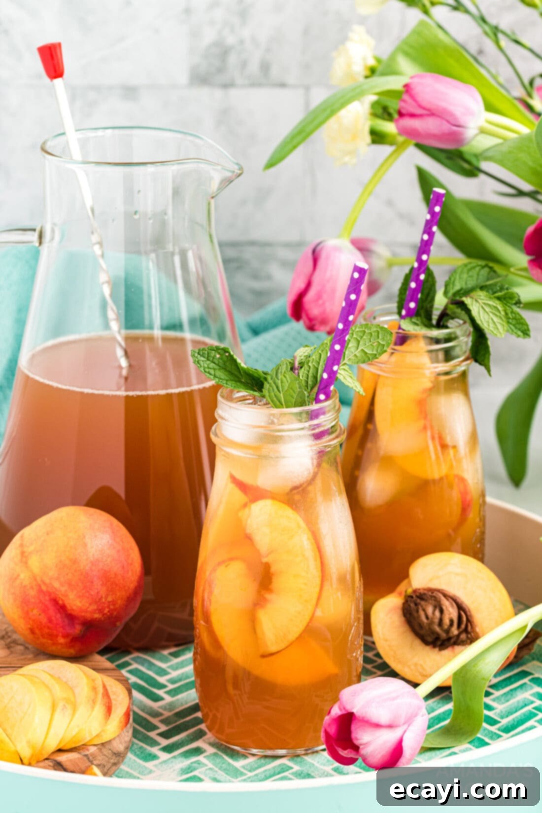 Sun-Kissed Peach Brew 3 Two glass bottles of homemade peach iced tea, ready for serving.