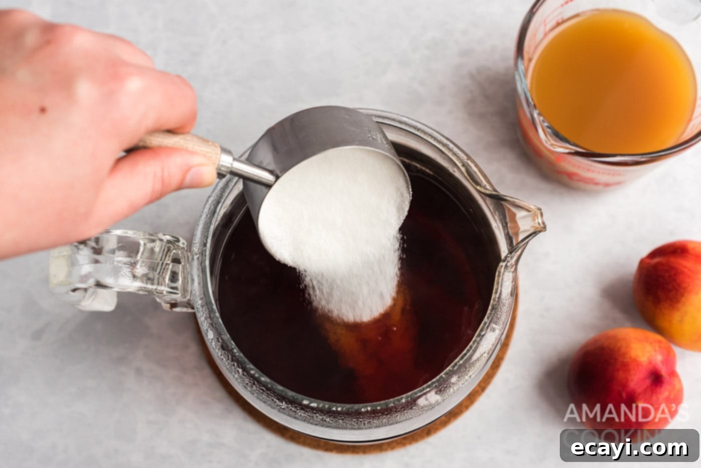 Sun-Kissed Peach Brew 6 Stirring granulated sugar into the cold brewed tea.