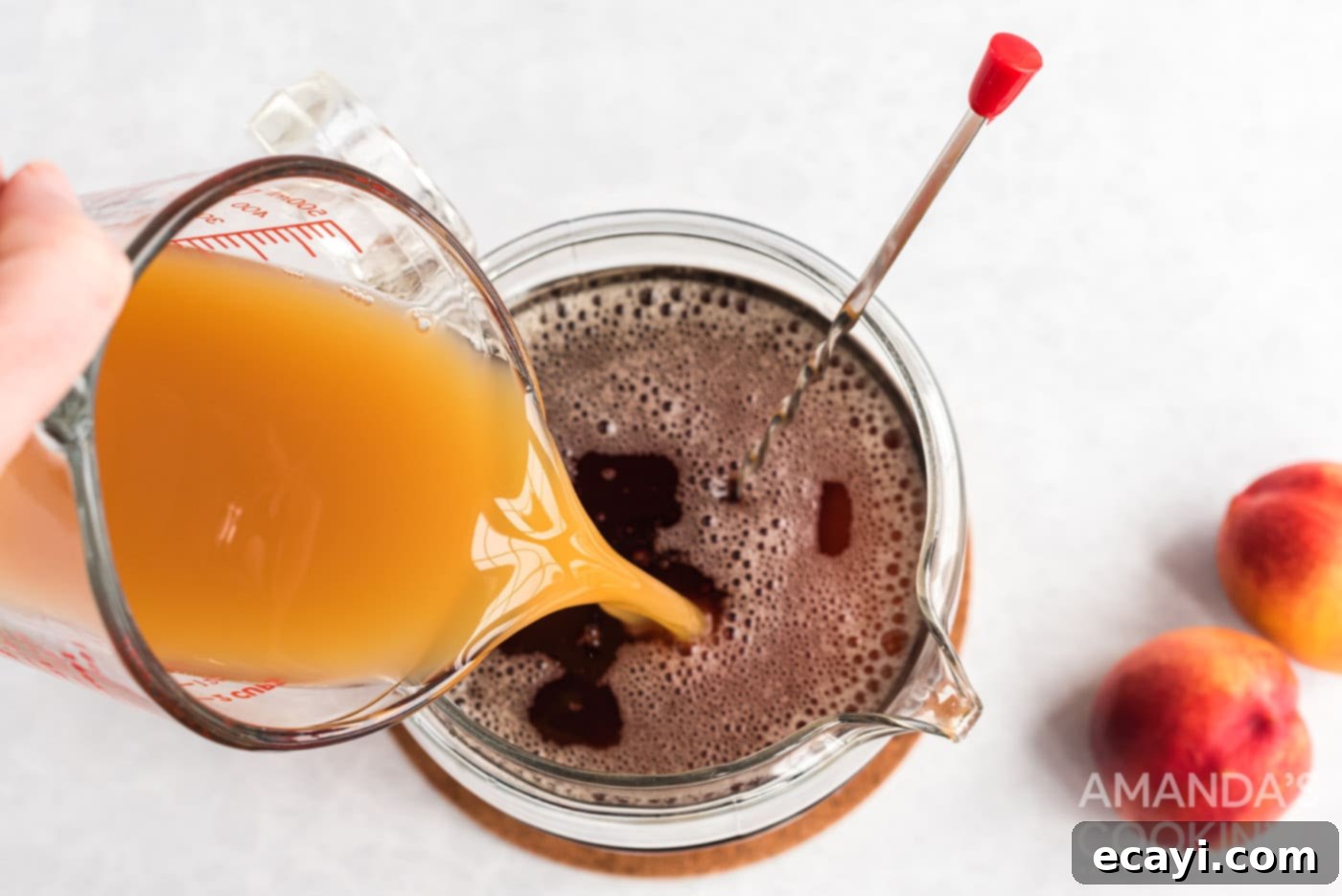 Sun-Kissed Peach Brew 7 Pouring peach nectar into the sweetened cold brew tea.