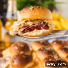Reuben Bites 11 Delicious Reuben Sliders baked to perfection on a white plate, ready to be served.