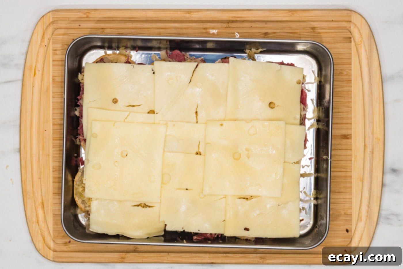 Reuben Bites 7 Swiss cheese slices covering the sauerkraut and corned beef layers.