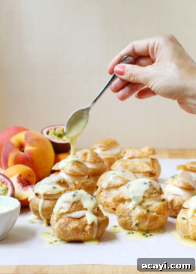 Çarkıfelek, Kayısı ve Şeftalili Ekler 6 Stacked Peach Cream Puffs on a serving plate, ready to be enjoyed