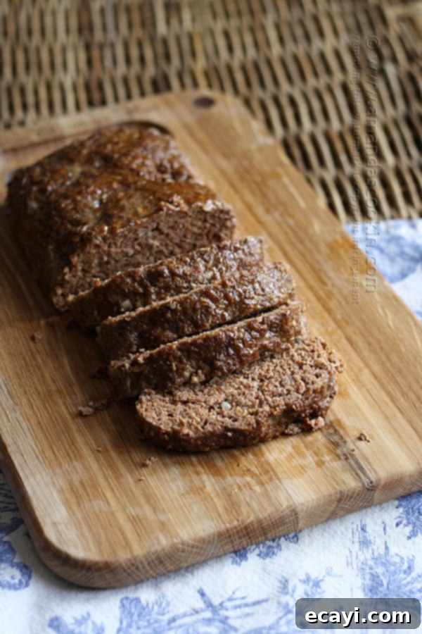 Quaker Oats Ultimate Meatloaf 2 A photo of sliced Quaker oats meatloaf on a wooden cutting board.