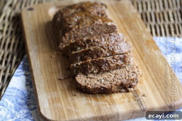 Quaker Oats Ultimate Meatloaf 3 A photo of sliced Quaker oats meatloaf on a wooden cutting board.