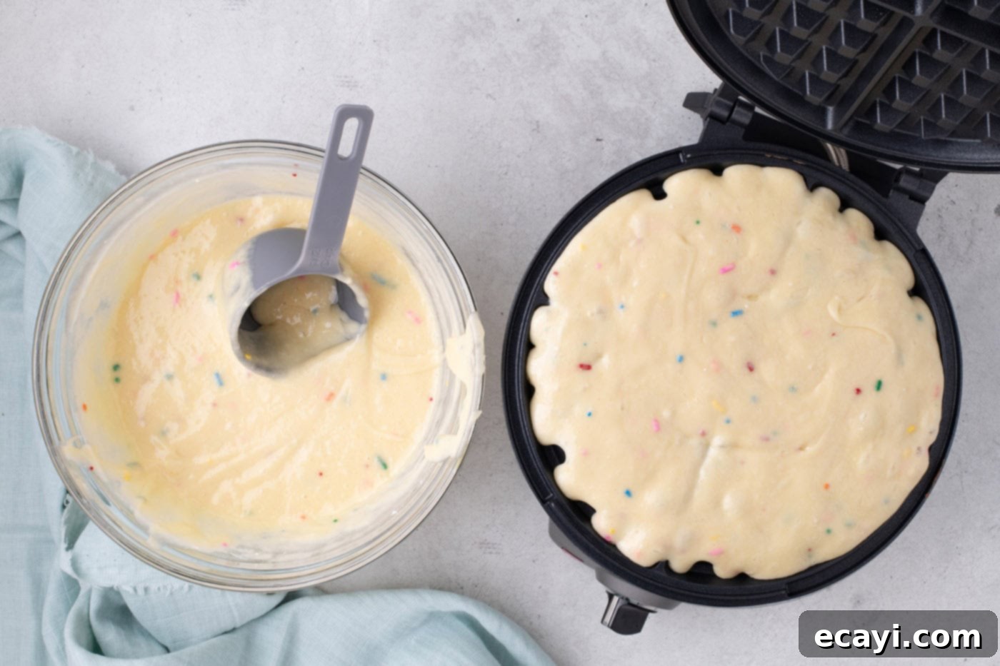 Cake Mix Waffle Wonders 6 cake mix batter being poured into a waffle iron.