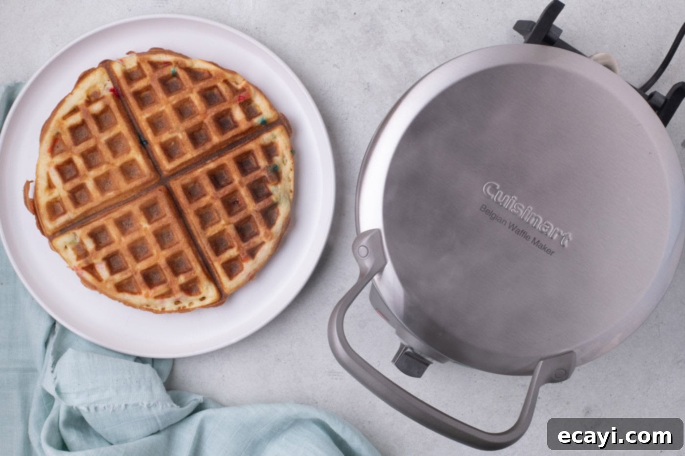 Cake Mix Waffle Wonders 7 A plate of golden brown cake mix waffles, freshly cooked and ready to be stacked.