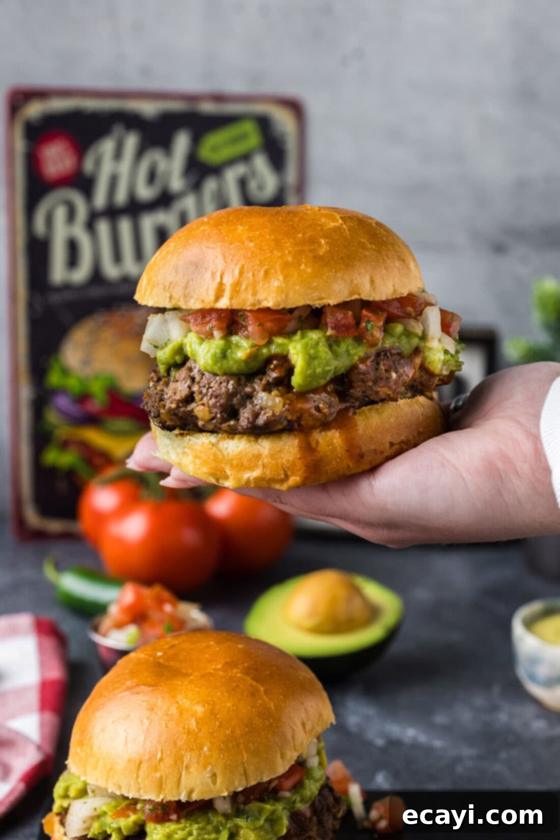 Taco Burger Fusion 3 A hand holding up a generously topped Taco Burger, highlighting its texture and vibrant ingredients.