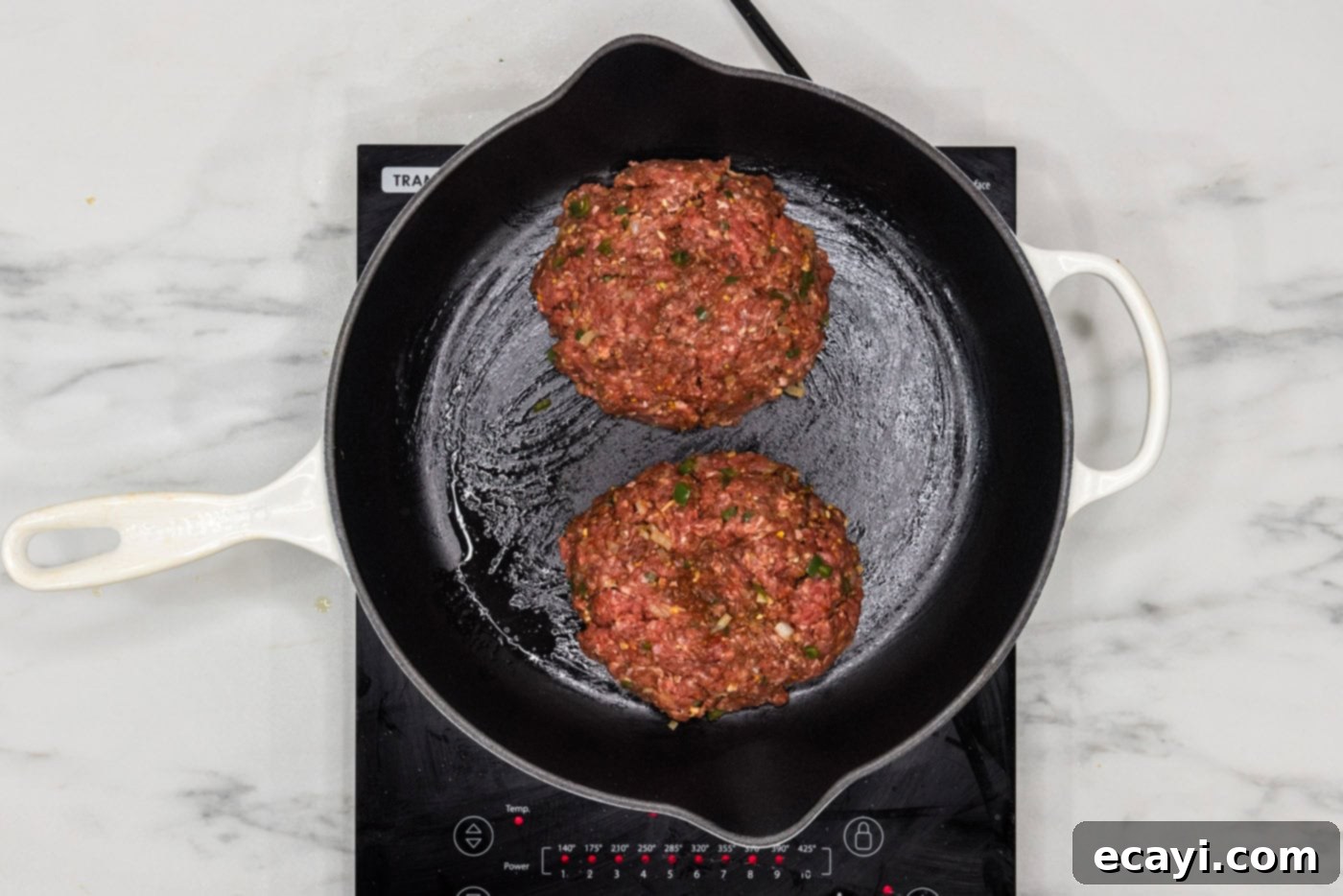 Taco Burger Fusion 8 Several burger patties sizzling in a hot skillet, showing a beautiful sear.