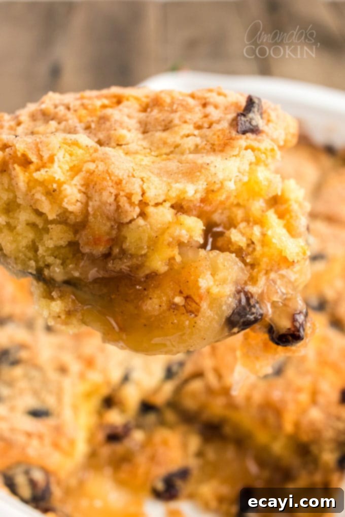 Fall is all about apples and cranberries. We love our apple cobbler all year long, but reserve this Cranberry Apple Cobbler for the autumn months. scooping apple cranberry cobbler out of pan