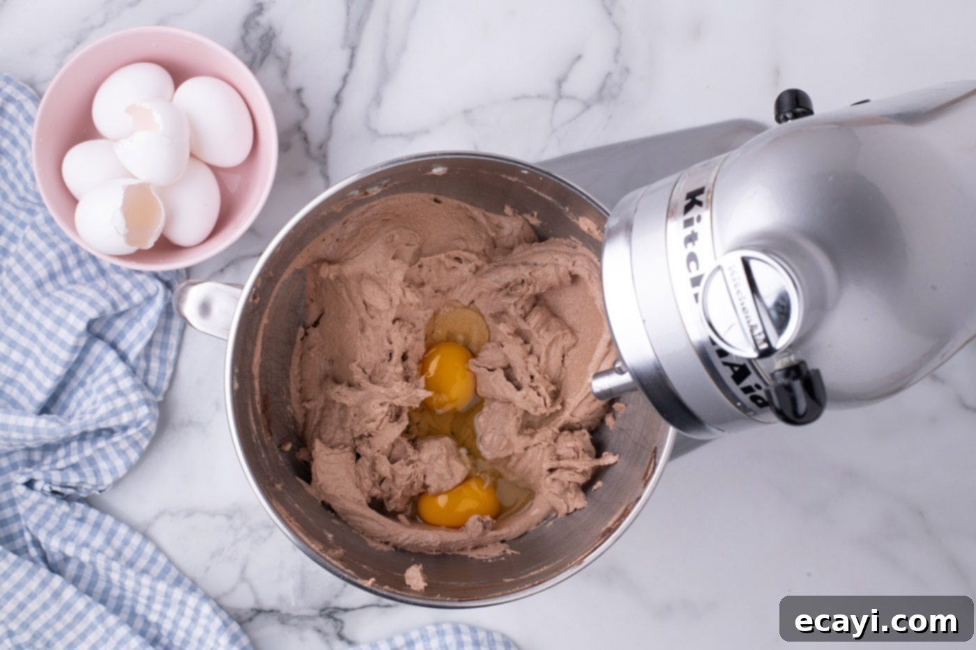 Ultimate French Silk Sheet Pie 10 adding eggs to pie filling mixture in a mixer bowl