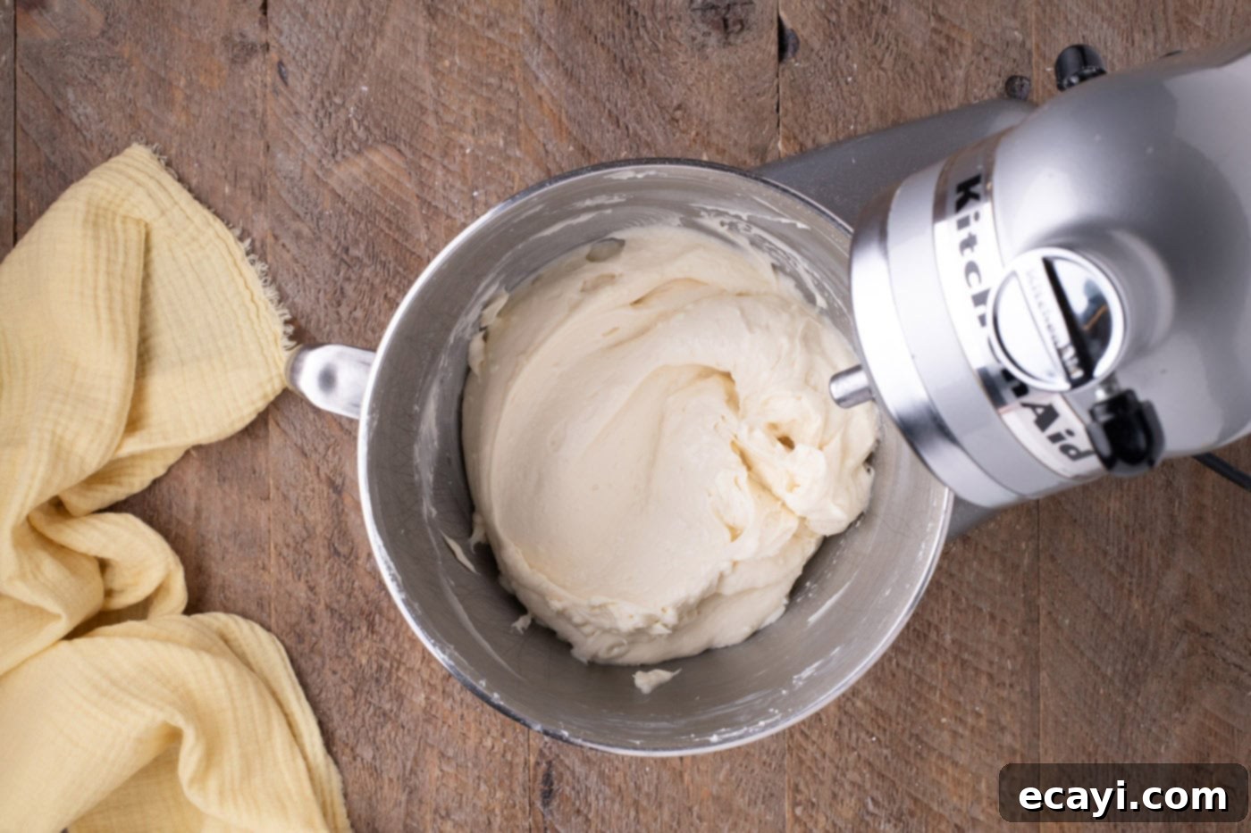 Zesty Lemon Blueberry Bliss 12 Silky smooth cream cheese frosting in a stand mixer bowl, ready for cake