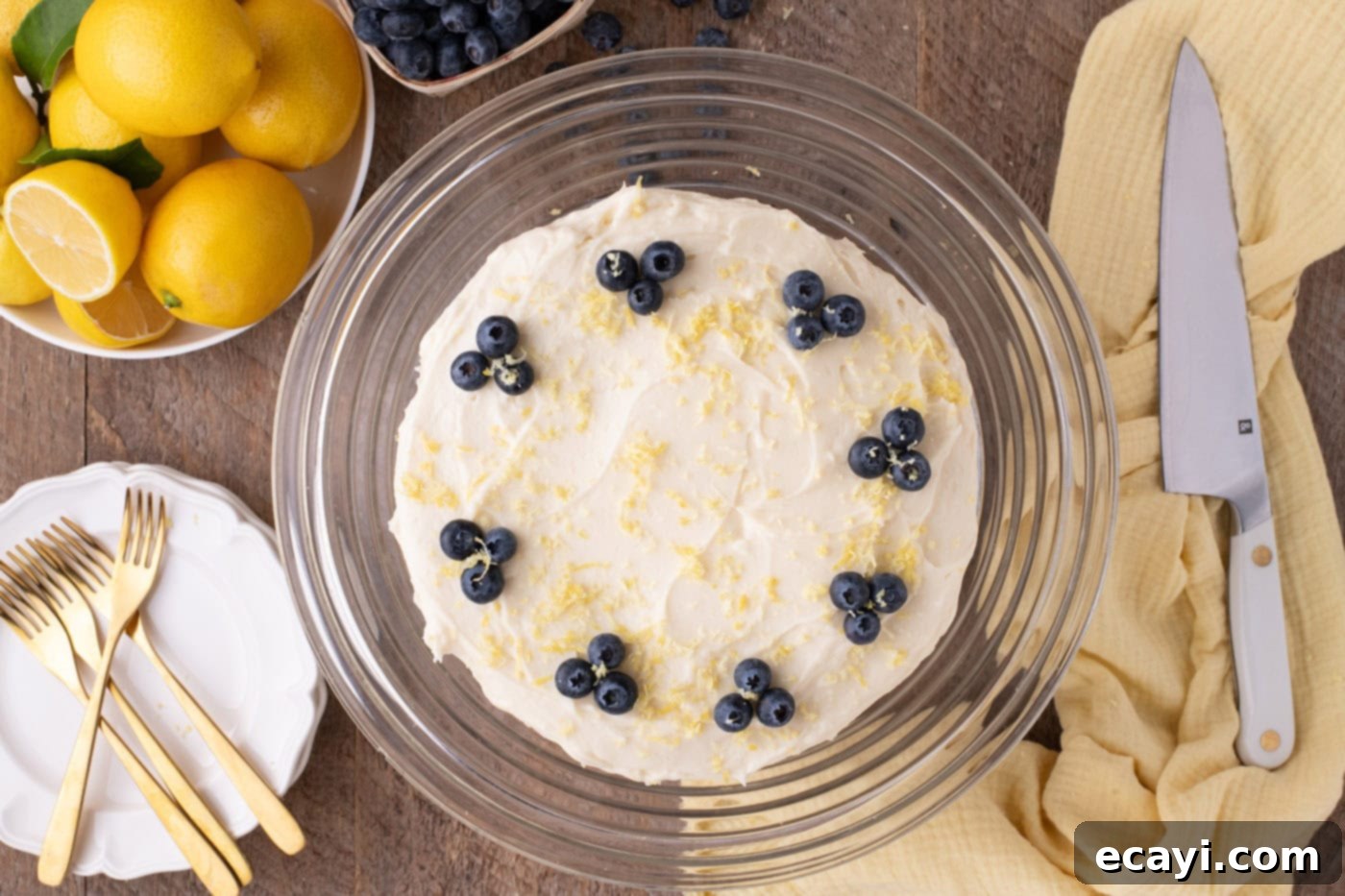 Zesty Lemon Blueberry Bliss 14 Decorating lemon blueberry cake with fresh blueberry clusters and lemon zest