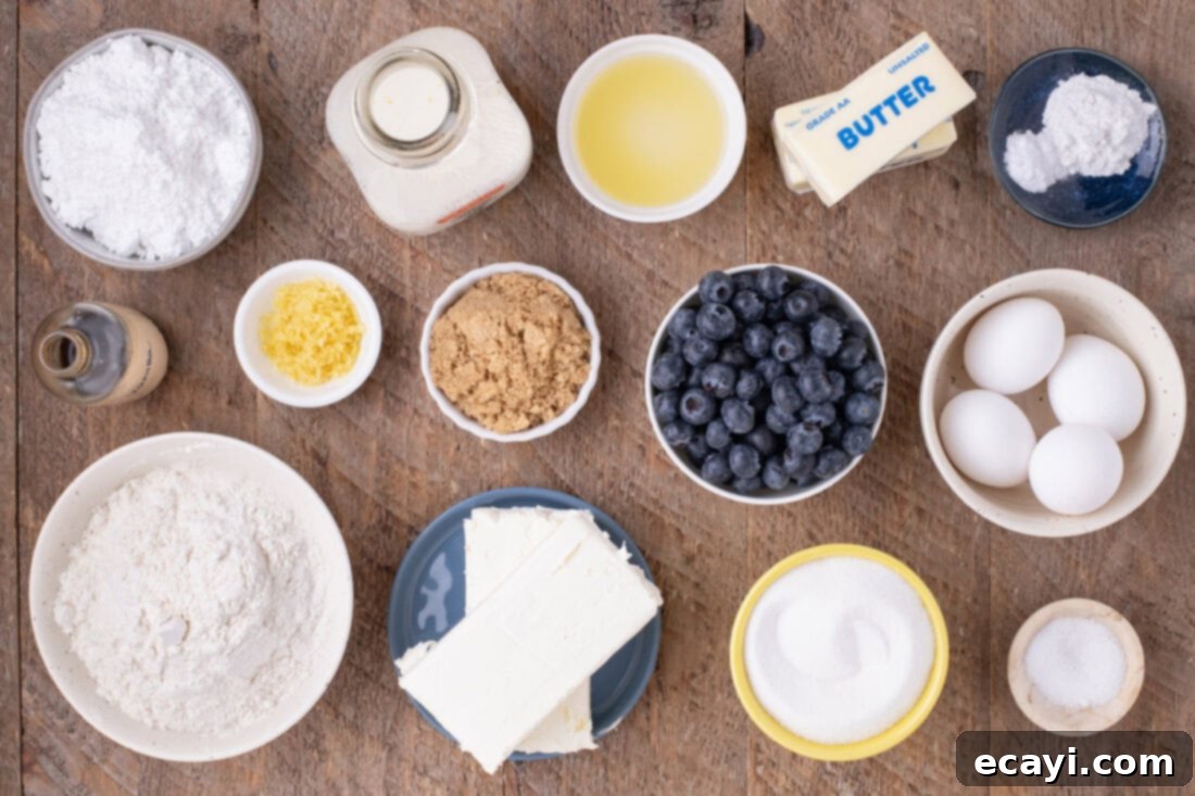 Zesty Lemon Blueberry Bliss 4 Collection of fresh ingredients for Lemon Blueberry Cake including lemons, blueberries, butter, eggs, flour, and sugar