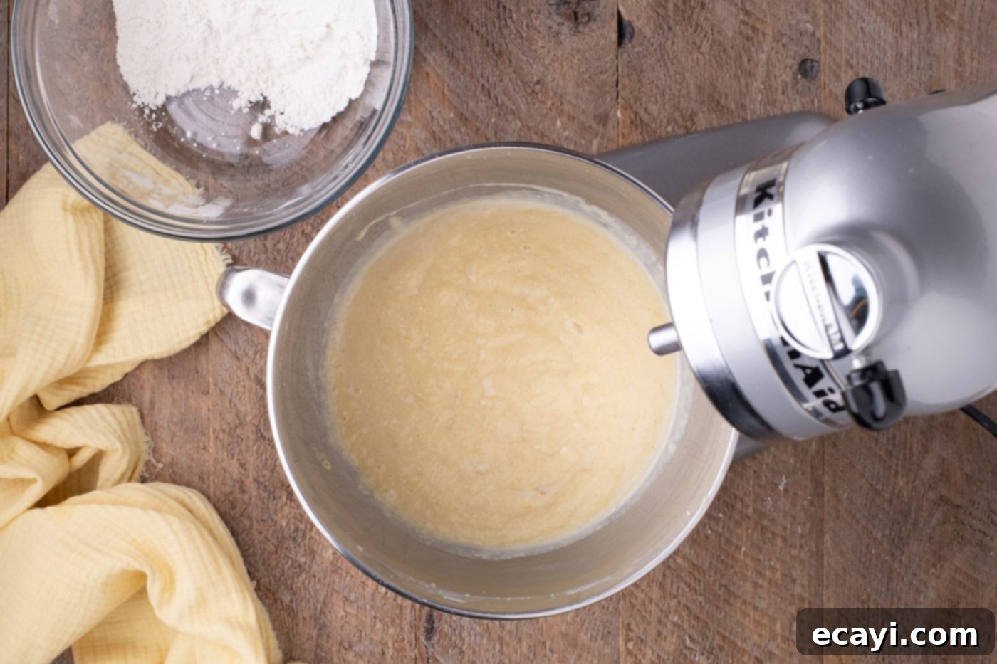 Zesty Lemon Blueberry Bliss 7 Smooth lemon cake batter in a mixer bowl, ready for blueberries