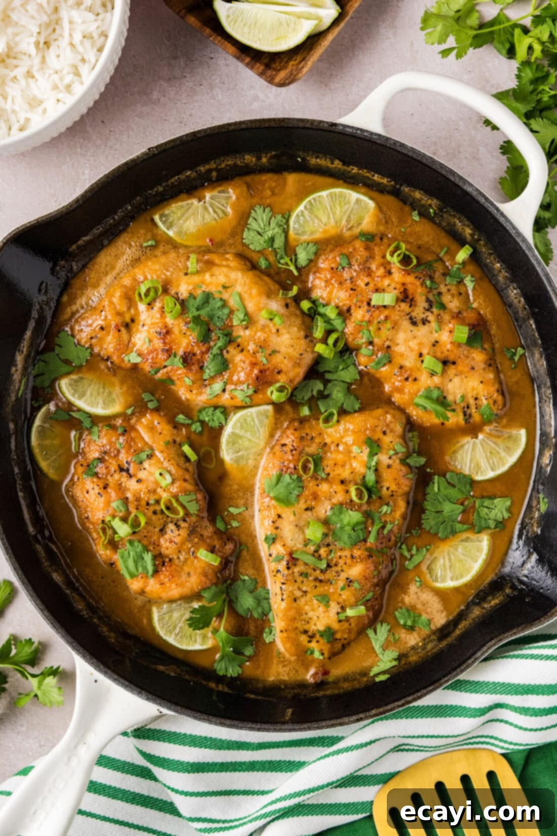 Tropical Coconut Chicken 2 Skillet of Coconut Chicken topped with limes and green onion
