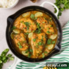 Tropical Coconut Chicken 11 Coconut Chicken in a skillet with rice, herbs and linens on the side