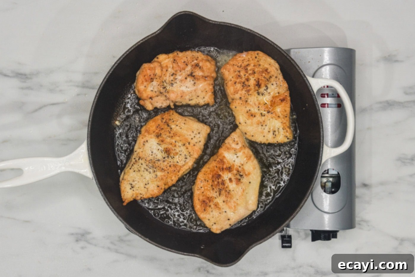 Tropical Coconut Chicken 8 seared chicken in a skillet