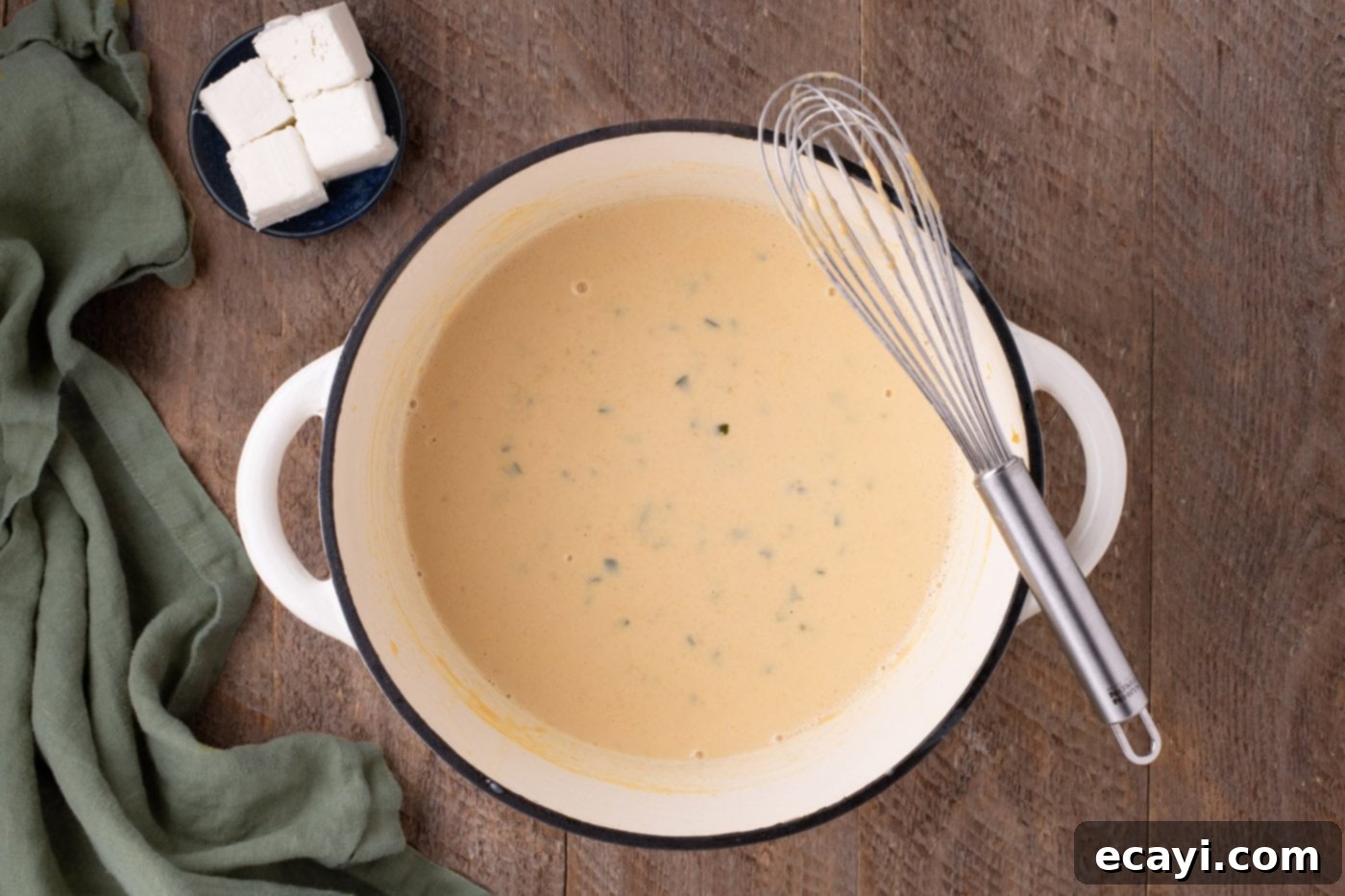 Spicy Cheesy Popper Mac 8 jalapeno cheese sauce in a pan with a whisk