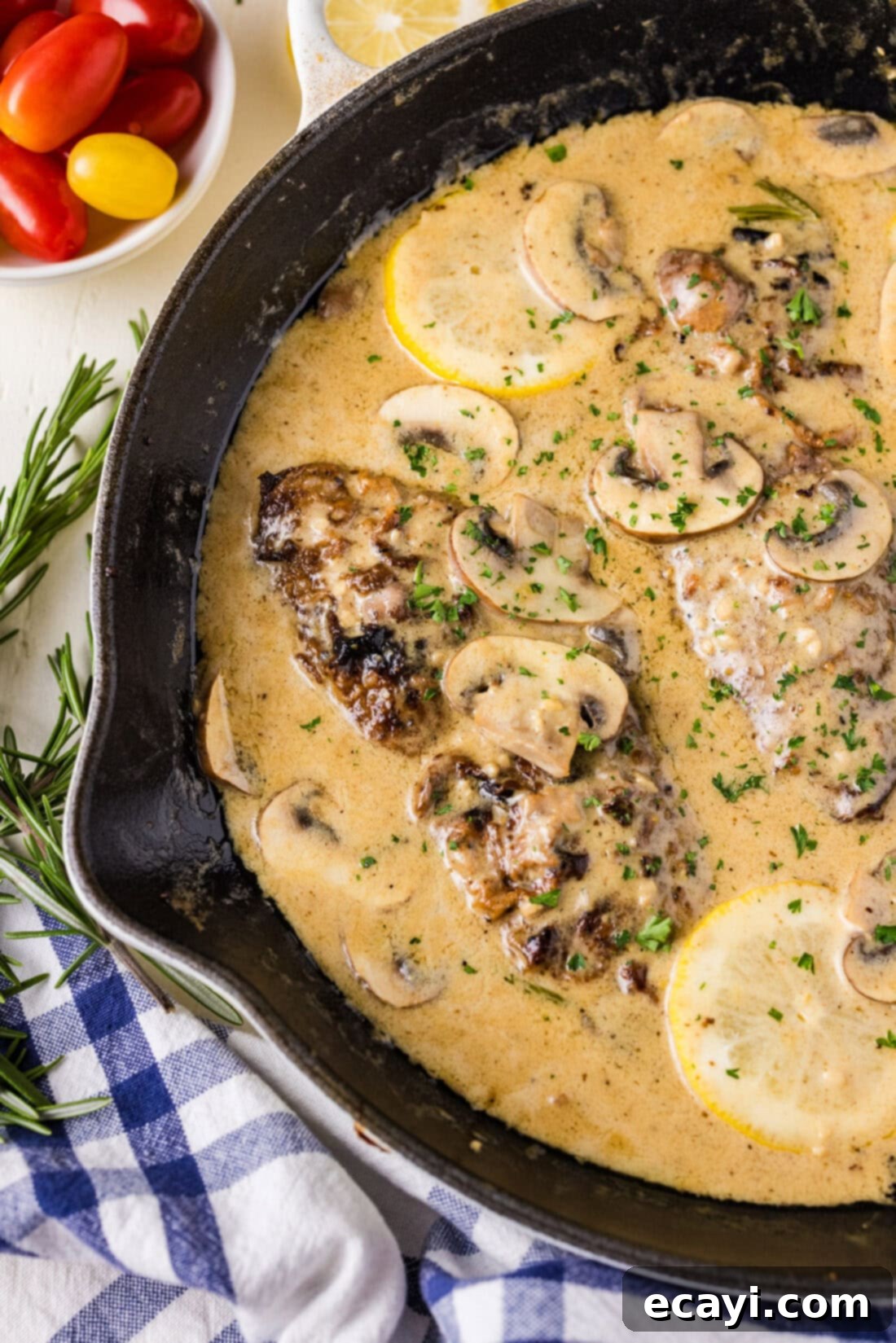 Delicate Veal Cutlets 3 Close up photo of a skillet of Veal Scallopini cooking, showcasing the rich sauce and mushrooms