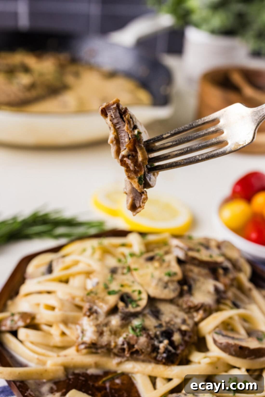 Delicate Veal Cutlets 9 A single piece of Veal Scallopini on a fork, showing its tenderness and sauce coating